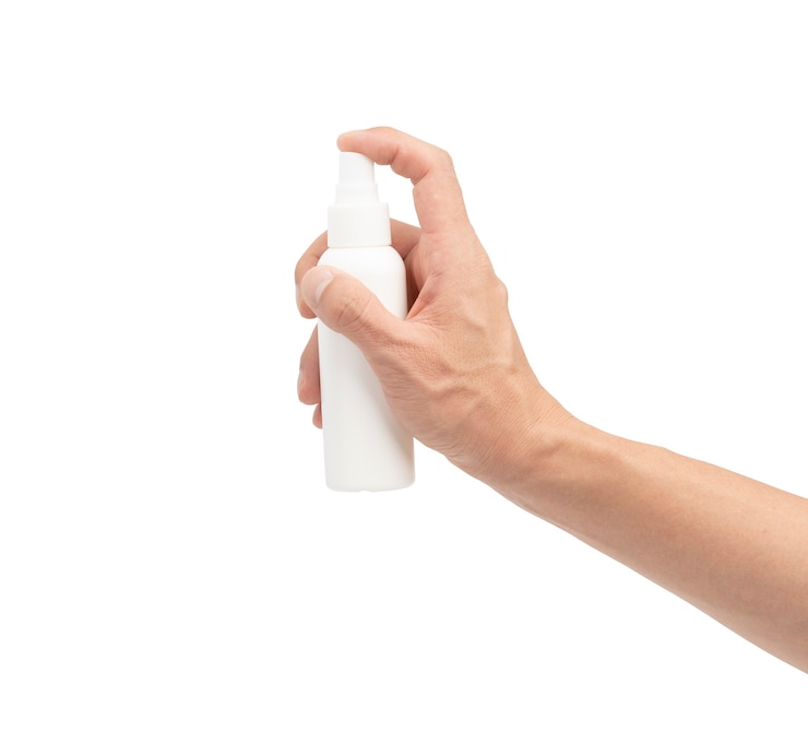 Photo hand pushes on alocohol spray
