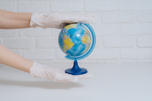 Photo hand pushing spray on earth globe model