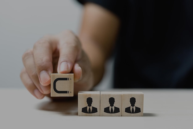 Hand put wooden cubes with Inbound marketing icons and symbols on table and copy spaceBusiness concepts