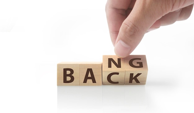 The hand puts a wooden cube with the letter  from the word. wooden cubes standing  in hand