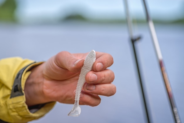 Hand putting bait on the hook