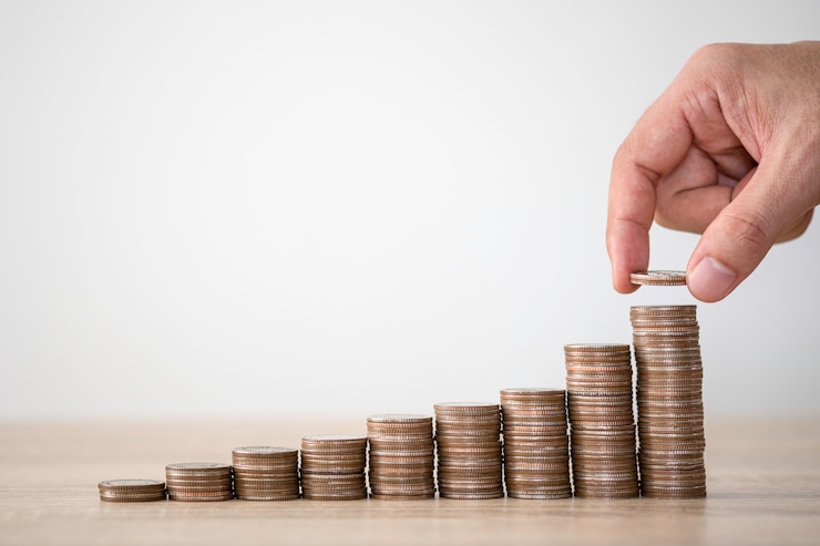Photo hand putting coins to stacking for money saving profit and business investment growth concept.