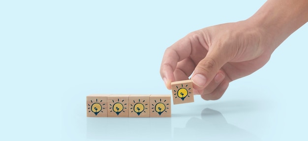 Hand putting wooden cube blocks