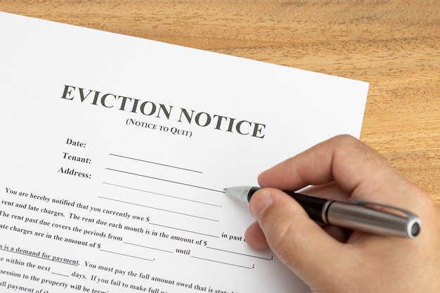 Photo hand ready to fill a eviction notice document