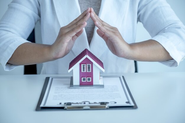 hand a real estate agent, prevent the home model and explain the business contract, rent, buy, mortgage, loan, or home insurance.