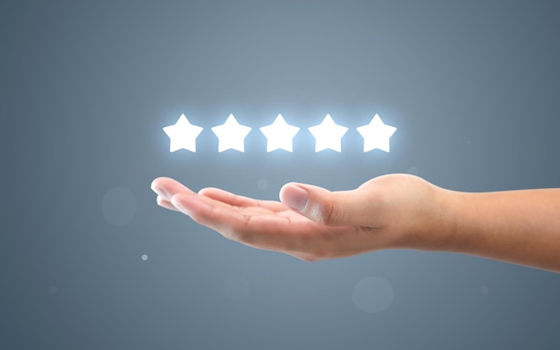 Hand review customer feedback glowing rating five star service
best product quality of ranking evaluation rate or user experience
good satisfaction and excellent business success on vote
background