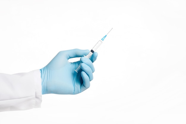 hand in rubber blue glove holding transparent syringe without cap Isolated on white background