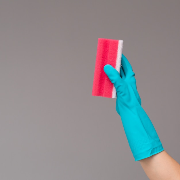 Photo hand in rubber glove holds color wash sponge