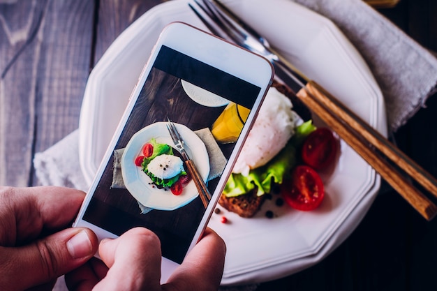 Hand's of men taking picture photo food with mobile smartphone