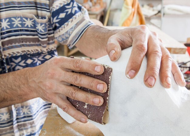 Photo hand sanded piece of white marble in the studio