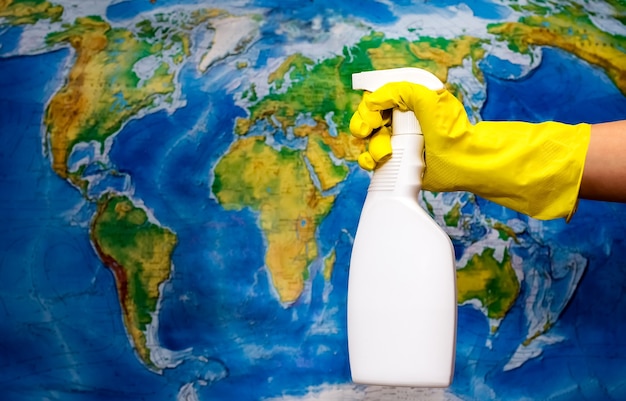 Hand sanitazer spray cleans the earth map