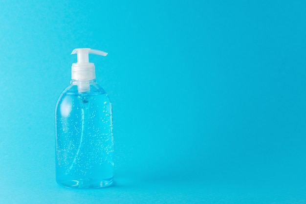 Hand sanitizer in a bottle on a bright background.