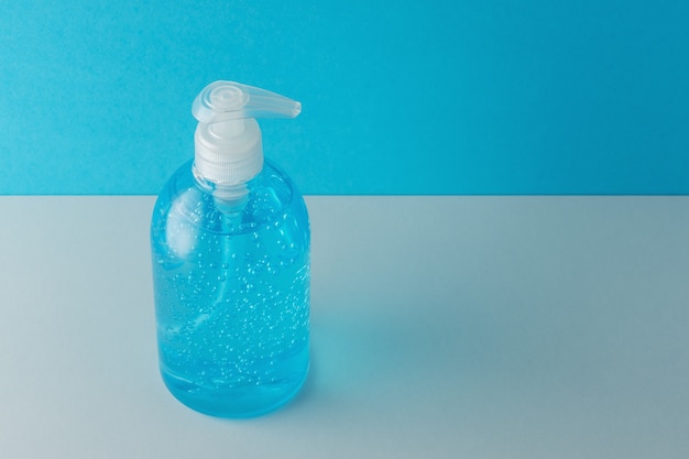 Photo hand sanitizer in a bottle on a bright background.