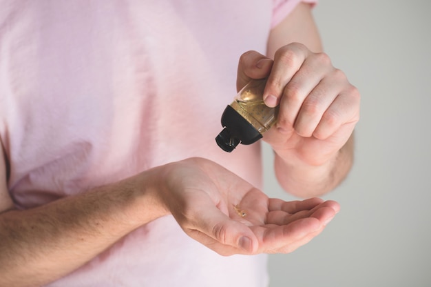 Hand sanitizer gel in male hands