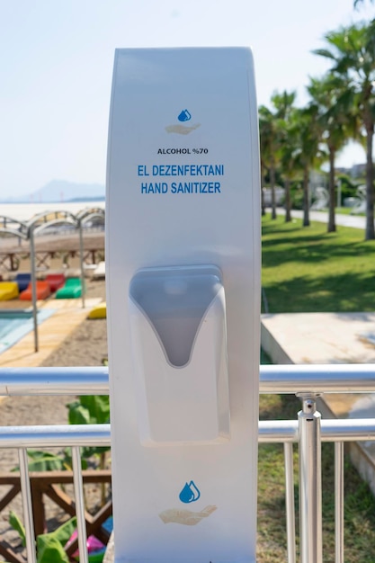 A hand sanitizer for hands standing at the beach