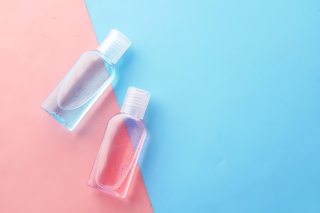 Hand sanitizer liquid in a plastic bottle on color background