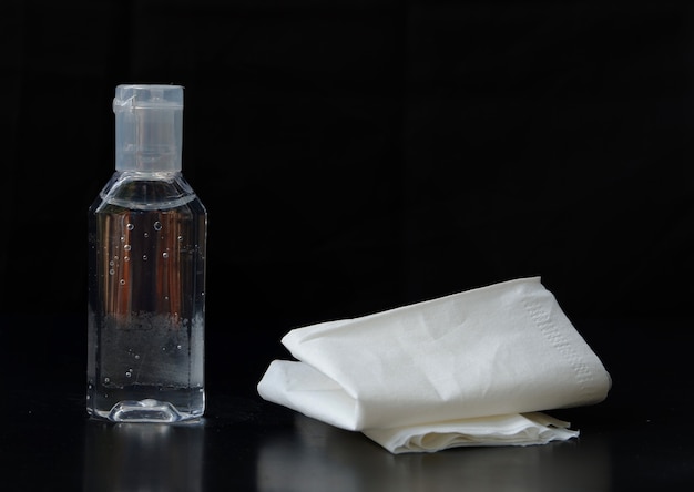 Photo hand sanitizer with tissue isolated on black background