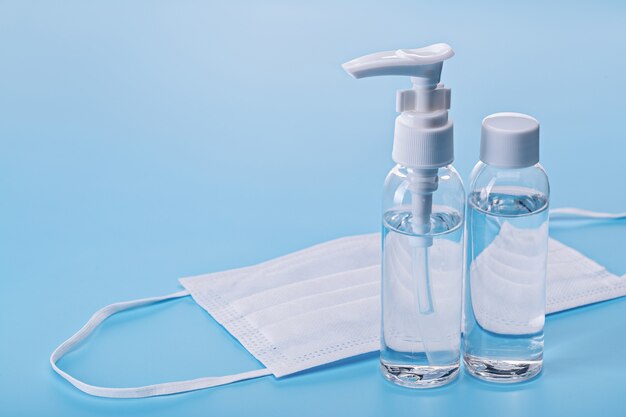Hand sanitizers, protection against viruses and bacteria. Medical mask, close-up, copy space.