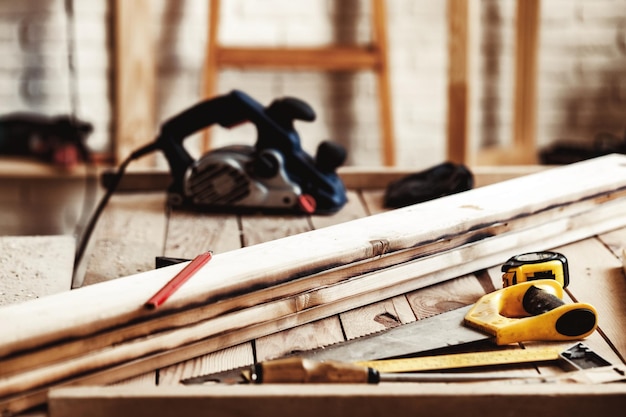 Hand saw on a wooden table in carpentry workshop