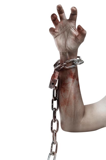 The hand of a scary zombie with blood and wounds tied on the iron chain is isolated over a white background