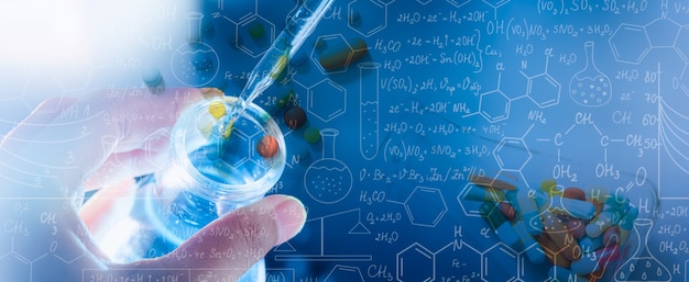 Hand of scientist holding flask with lab glassware and test tubes in chemical laboratory background