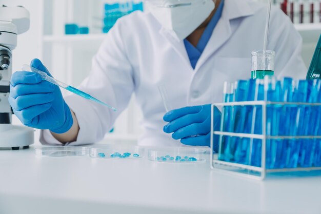 Hand of scientist with test tube and flask in medical chemistry lab blue banner background