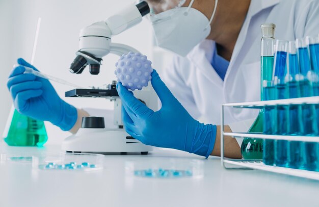 Hand of scientist with test tube and flask in medical chemistry lab blue banner background