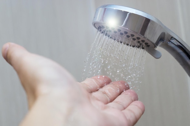 Hand in the shower test water temperature