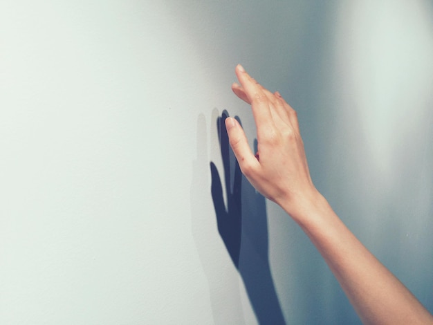 Photo hand sign shadow against white background