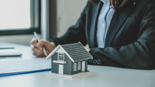 hand signing on contract after the real estate agent explains the business contract to the buyer