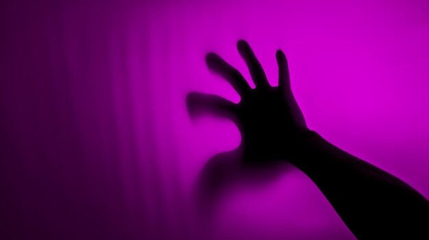 Hand silhouette on background Blurred human hand shape out of focus