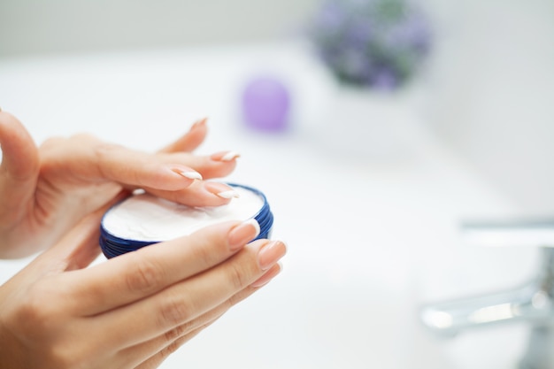 Hand Skin Care. Close Up Of Female Hands Holding Cream