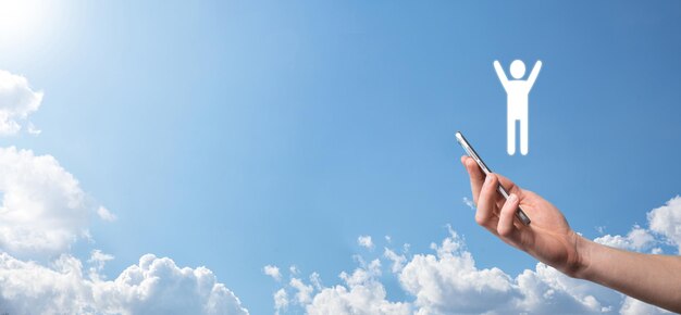 Hand on sky background holds human icon