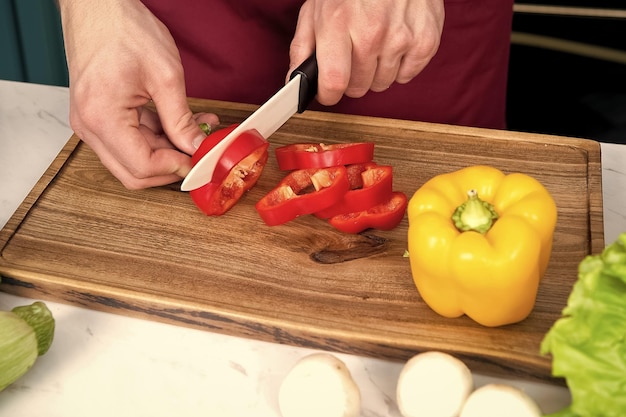 Hand slice red pepper with ceramic knife