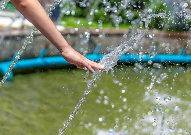 Hand in spray fountain