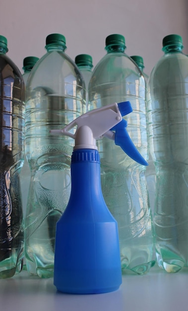 Hand Sprayer And Plastic Bottles Full Of Clear Water Vertical Stock Photo