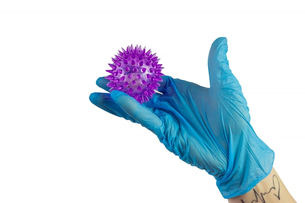 hand in sterile gloves holding a molecule model of virus of COVID-19