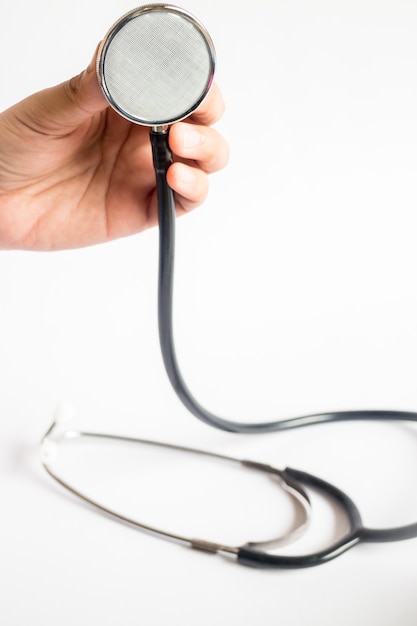 Hand on stethoscope on white background