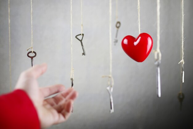 Hand stretching for one of the many old vintage keys hanging on threads