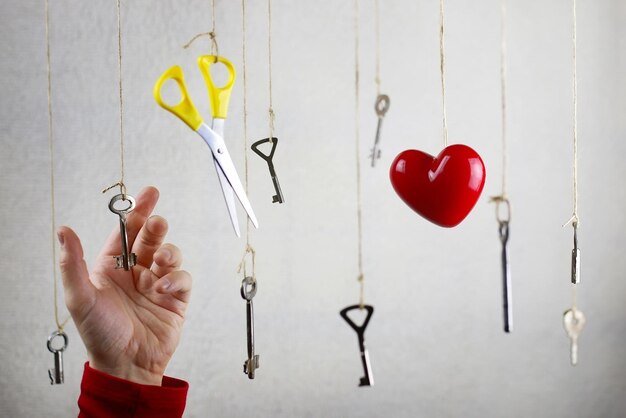 Hand stretching for one of the many old vintage keys hanging on threads