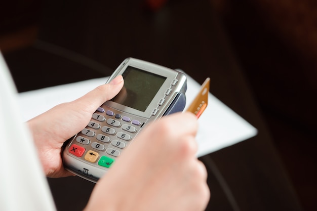 Hand swiping debit card on pos terminal