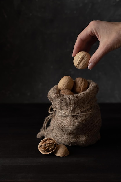 hand take the walnut out of the bag