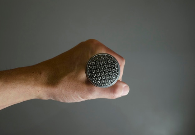 hand taking cardioid microphone headon