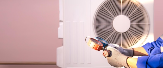 Hand technician using manifold gauge checking refrigerant air conditioner