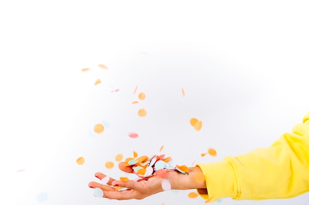 Photo hand throwing coloured confetti