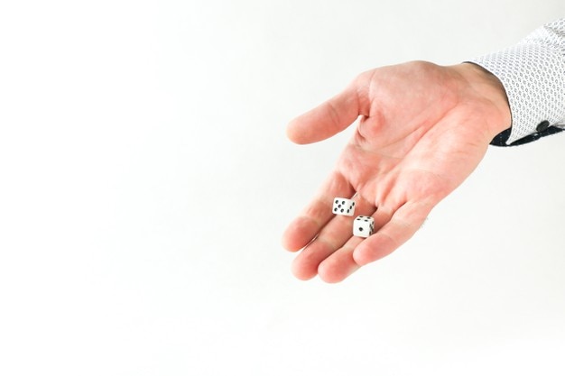 hand throws dice on white background