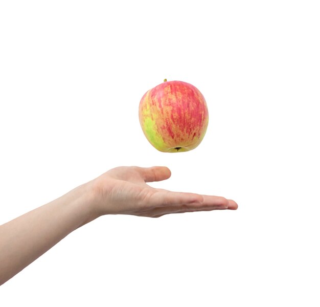 Hand throws up the apple isolated on a white background photo