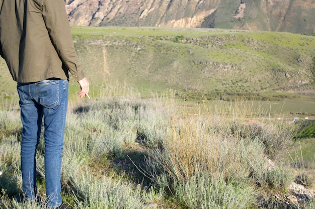 Hand tobacco in mountain background