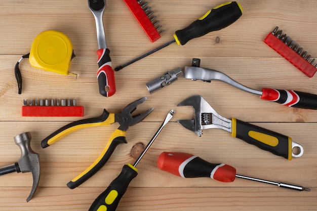 Hand tools laid out on a wooden table.