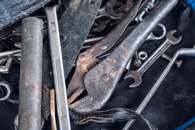 Hand tools with old rust wrench bolts keys in bag